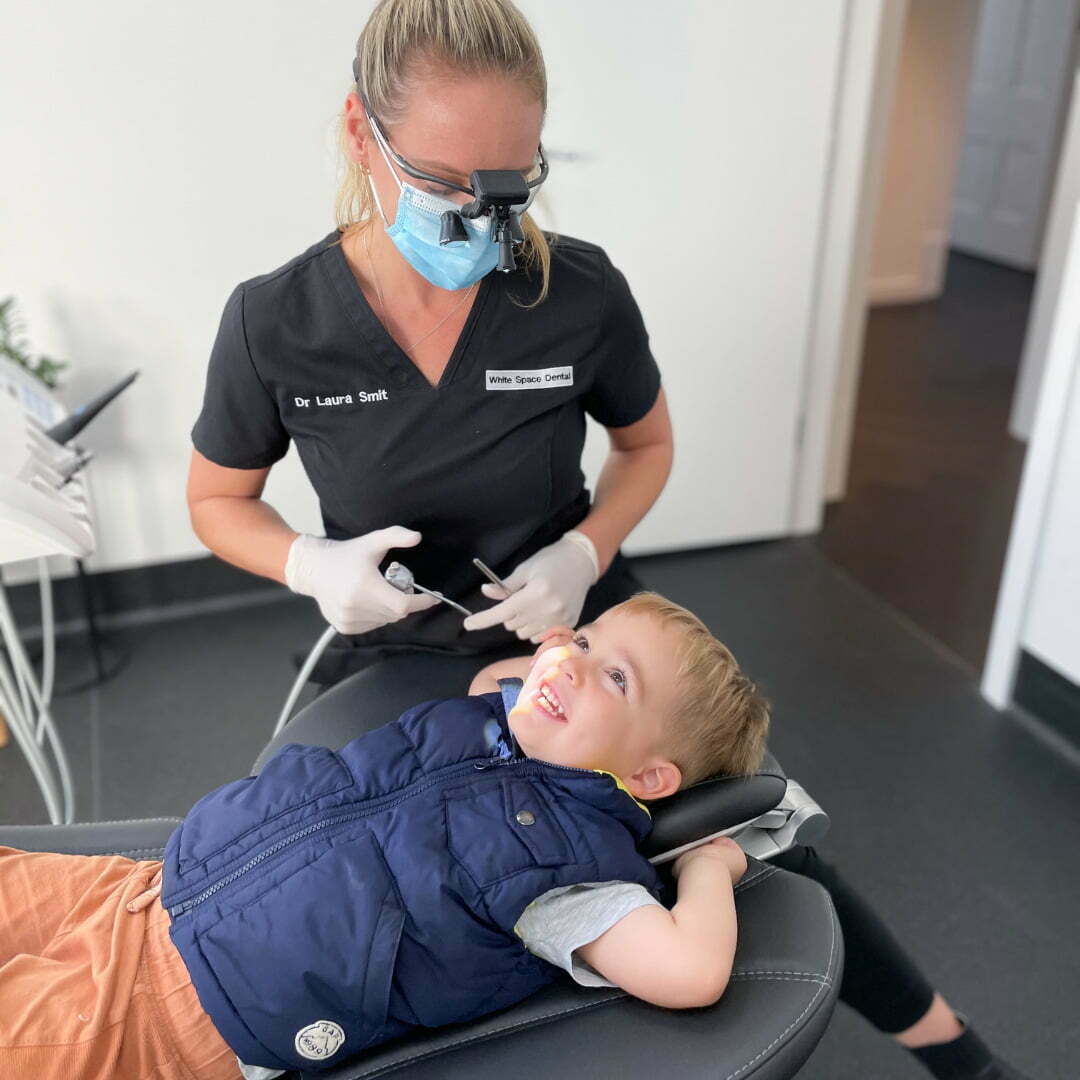 Laura treating a happy child